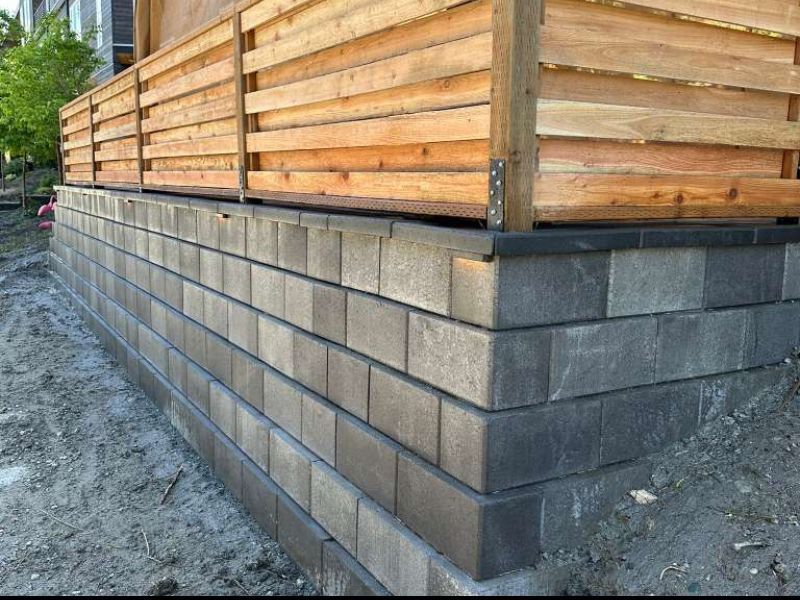Retaining wall and wood fence construction by Pro Pavers LLC in Kent WA